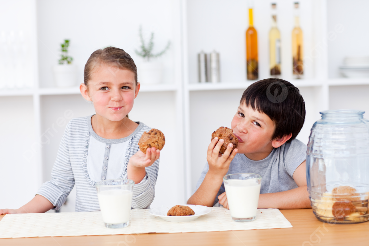 Children Drinking Milk In The Kitchen